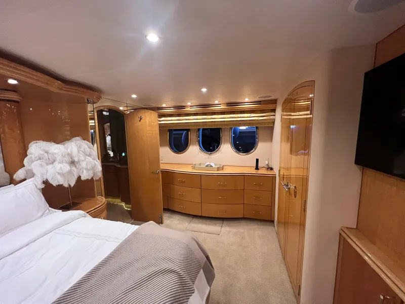 Slide: The Image of Luxurious bedroom interior of 2004 Hatteras 80 Motor Yacht with elegant wood finishes. - 27