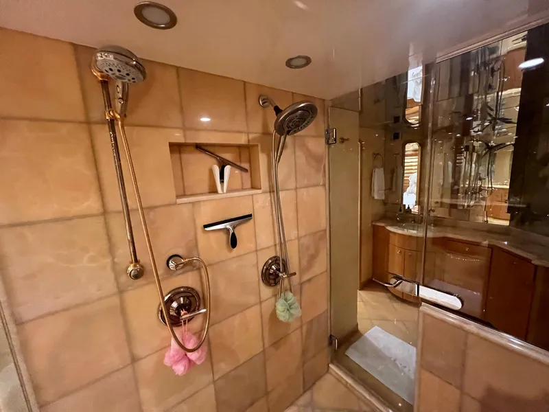 Slide: The Image of Luxurious shower in 2004 Hatteras 80 Motor Yacht with dual showerheads and elegant tile design. - 31
