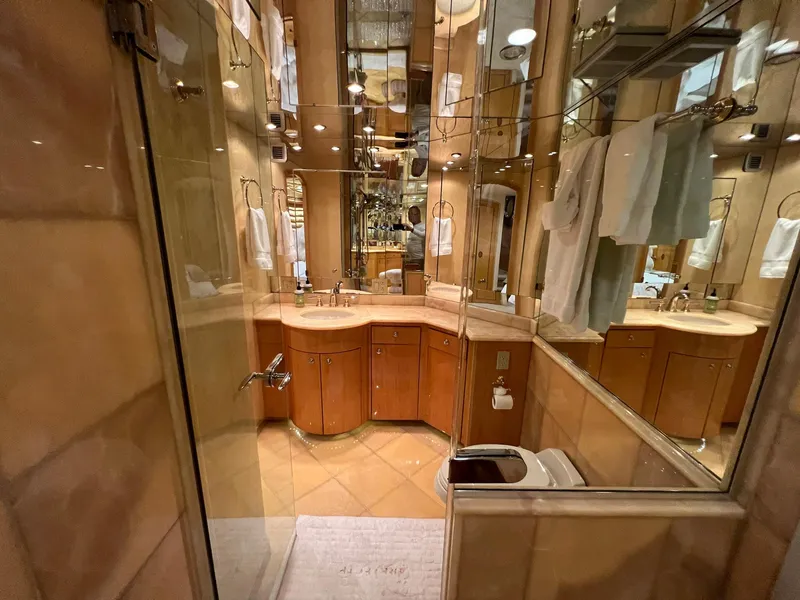 Slide: The Image of Luxurious bathroom in 2004 Hatteras 80 Motor Yacht with elegant wood cabinetry and mirrored walls. - 32