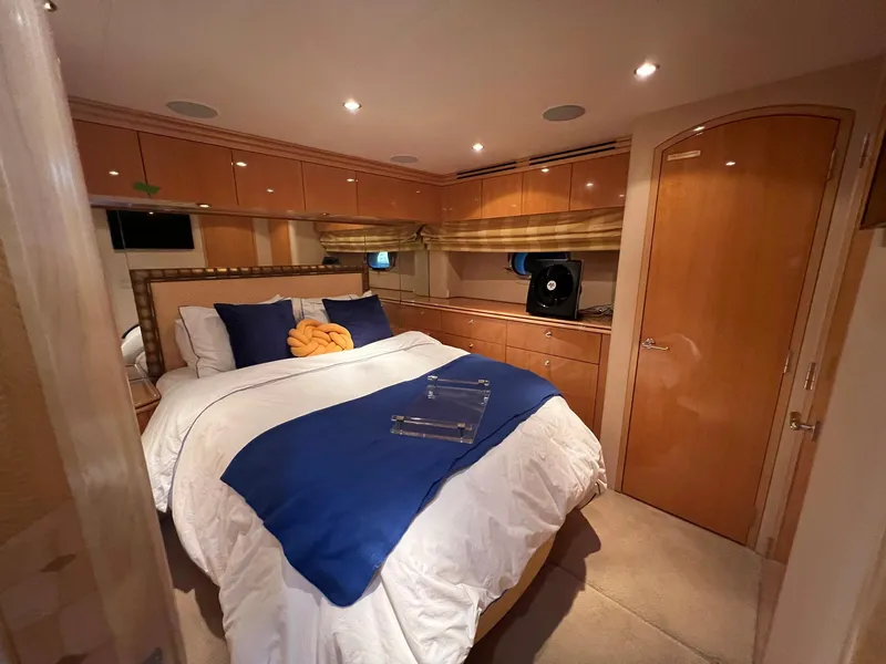Slide: The Image of Luxurious bedroom in 2004 Hatteras 80 Motor Yacht with elegant wood finishes and cozy bedding. - 37