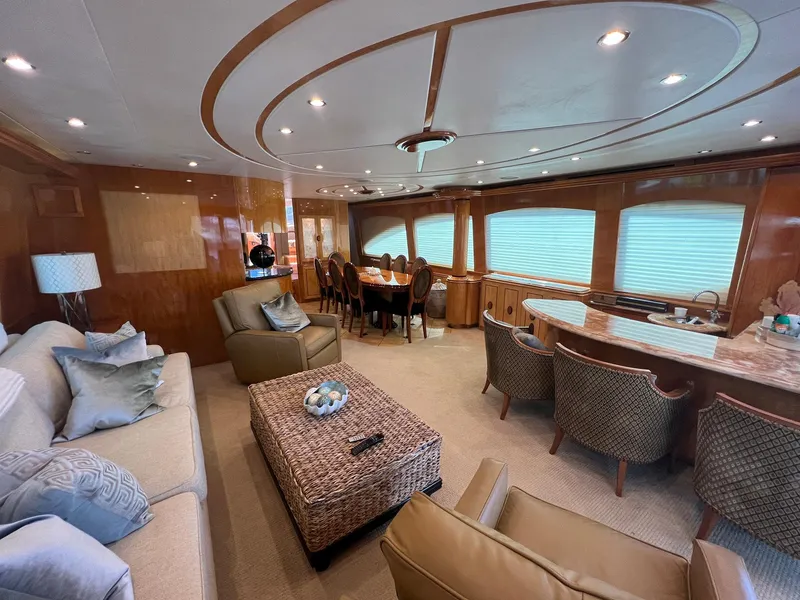 Slide: The Image of Luxurious interior of 2004 Hatteras 80 Motor Yacht with elegant seating and dining area. - 4