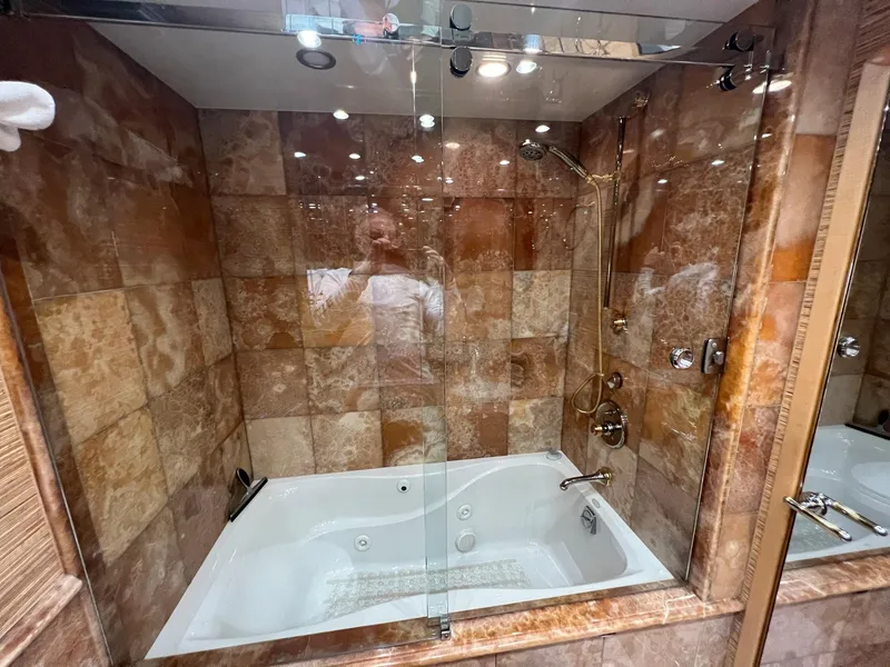 Slide: The Image of Luxurious marble-tiled bathtub in 2004 Hatteras 80 Motor Yacht bathroom. - 40