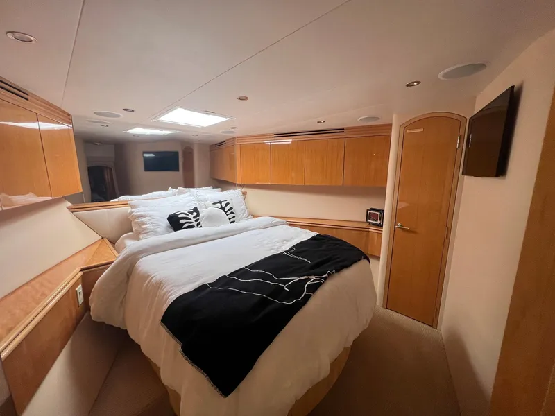Slide: The Image of Luxurious bedroom interior of 2004 Hatteras 80 Motor Yacht with wood cabinetry and cozy bedding. - 41