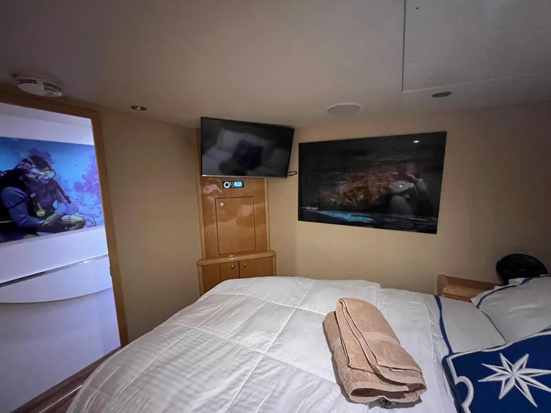 Slide: The Image of Luxurious bedroom in 2004 Hatteras 80 Motor Yacht with TV and artwork. - 45