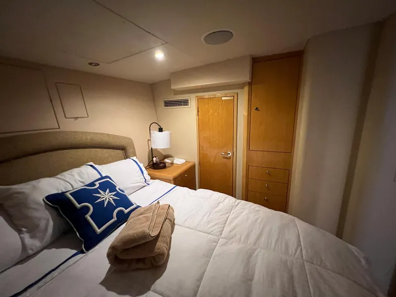 Slide: The Image of Cozy bedroom in 2004 Hatteras 80 Motor Yacht with elegant decor and soft lighting. - 46