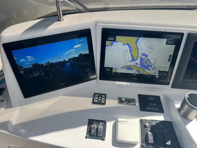 Slide: The Image of Navigation screens on a 2004 Hatteras 80 Motor Yacht dashboard. - 49