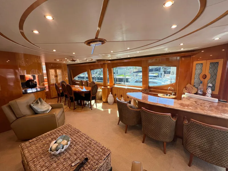 Slide: The Image of Luxurious interior of 2004 Hatteras 80 Motor Yacht with elegant dining area and seating. - 5
