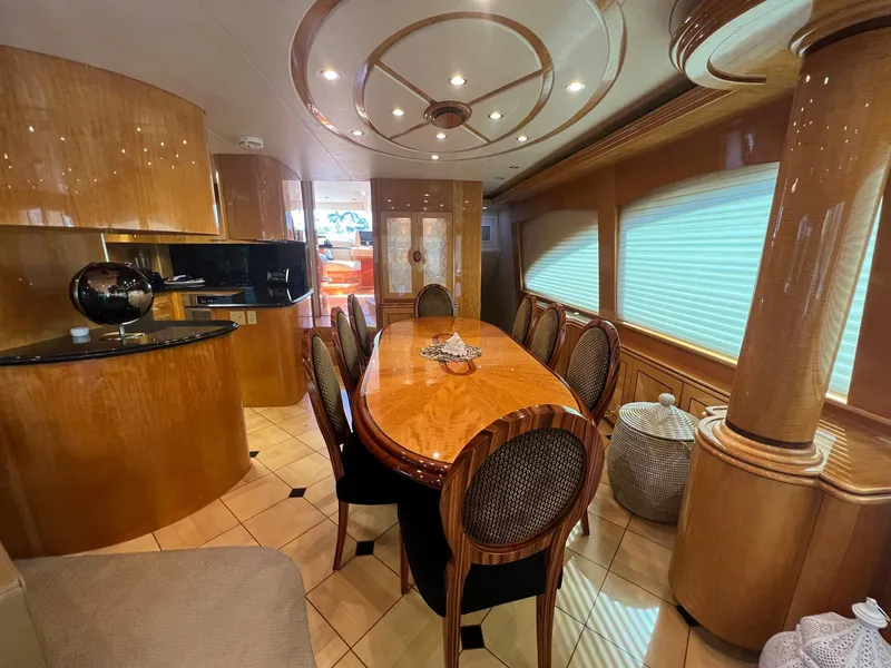 Slide: The Image of Luxurious dining area in 2004 Hatteras 80 Motor Yacht with elegant wood finishes. - 6
