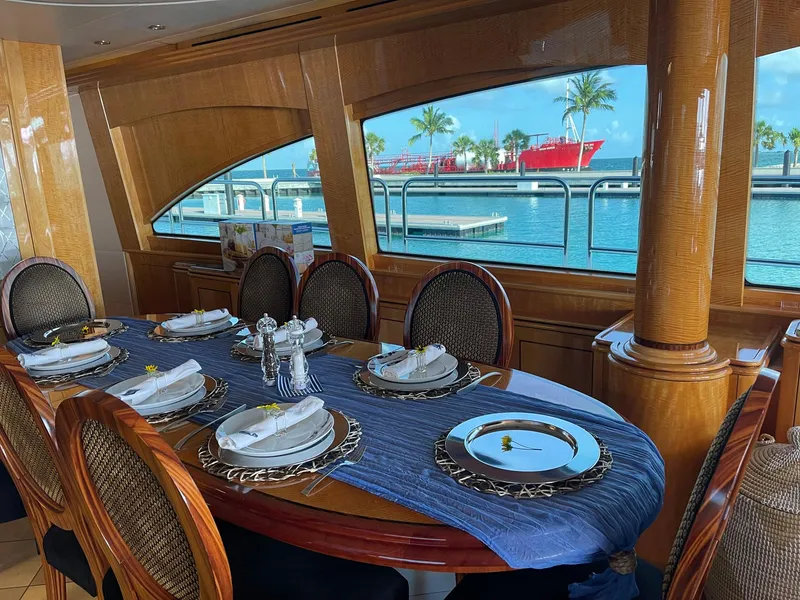 Slide: The Image of Luxurious dining area on 2004 Hatteras 80 Motor Yacht with ocean view. - 7