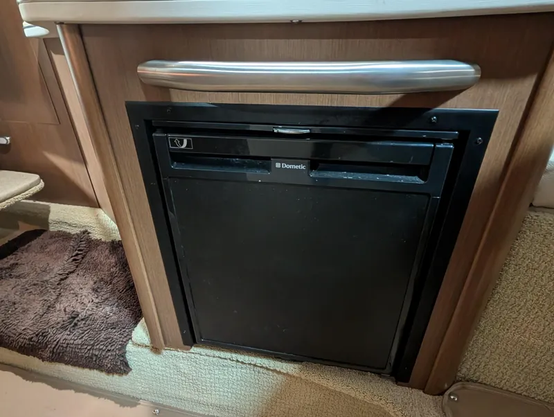 Slide: The Image of Compact fridge in 2015 Sea Ray 280 Sundancer cabin interior. - 14
