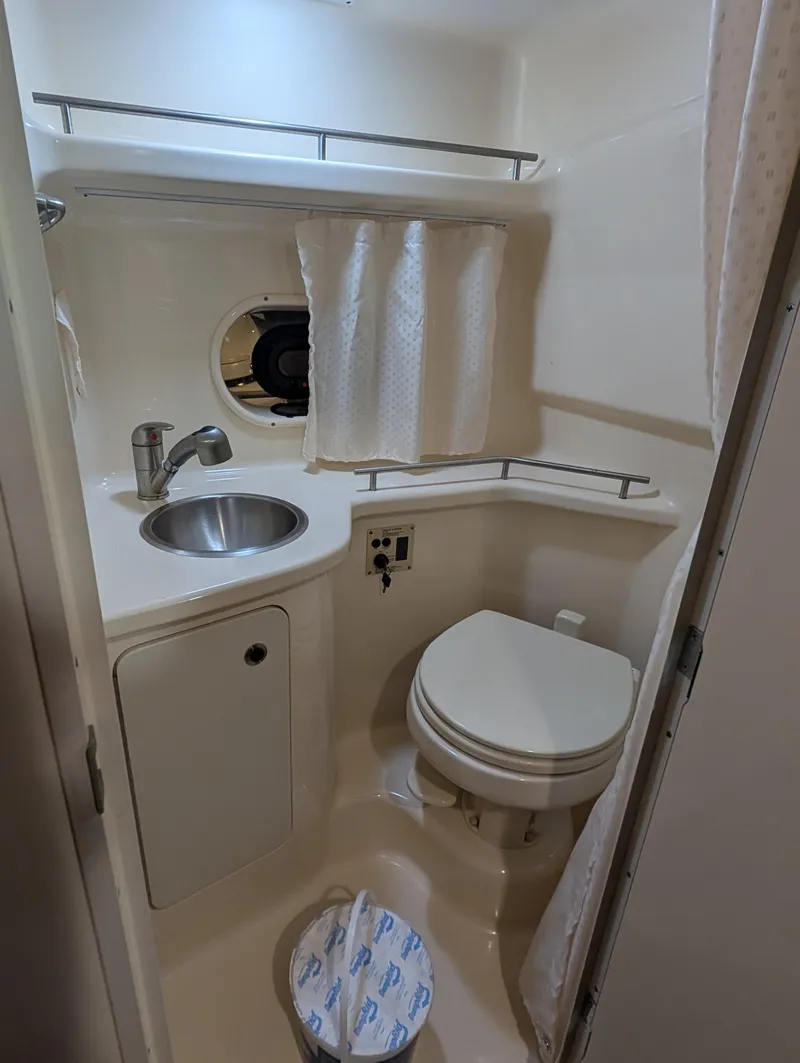 Slide: The Image of Compact bathroom in 2015 Sea Ray 280 Sundancer boat with sink and toilet. - 15