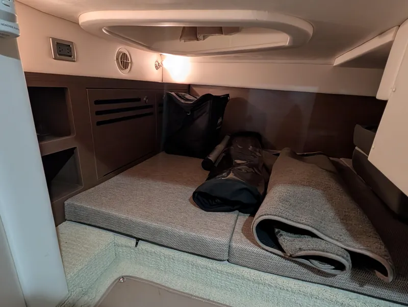 Slide: The Image of Interior cabin of 2015 Sea Ray 280 Sundancer with storage and seating area. - 17