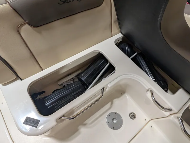 Slide: The Image of Storage compartment on 2015 Sea Ray 280 Sundancer boat with black fenders. - 23