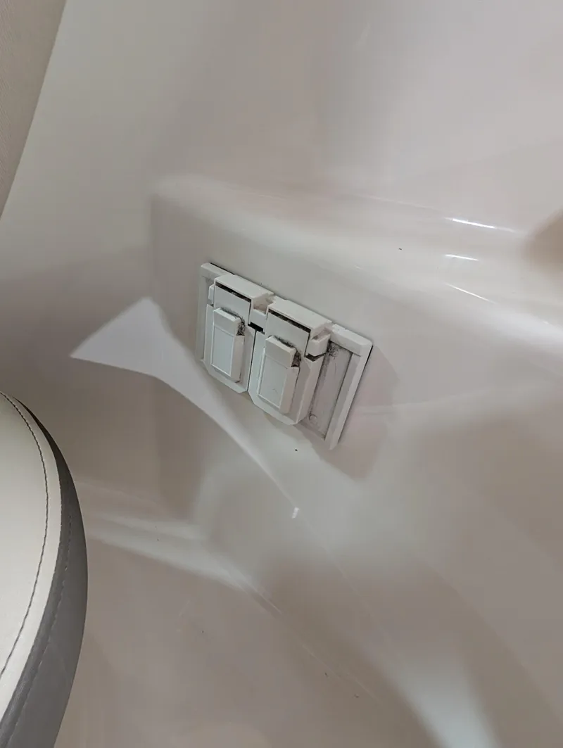 Slide: The Image of 2015 Sea Ray 280 Sundancer interior with white electrical switches. - 25