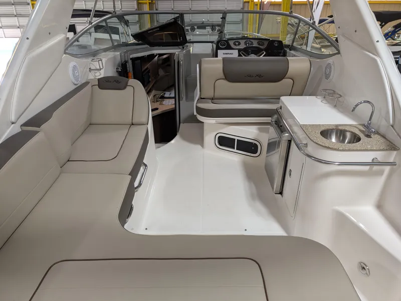 Slide: The Image of 2015 Sea Ray 280 Sundancer interior with seating, kitchenette, and helm. - 3