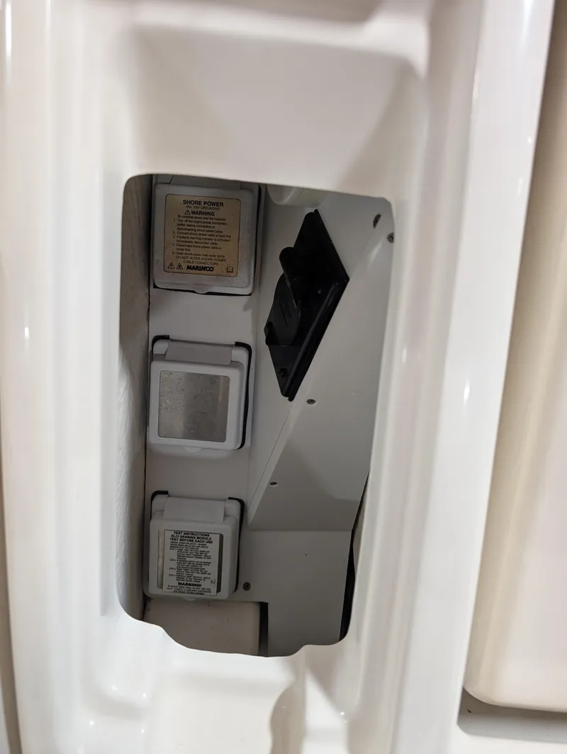 Slide: The Image of Sea Ray 280 Sundancer 2015 electrical panel with switches and labels. - 31