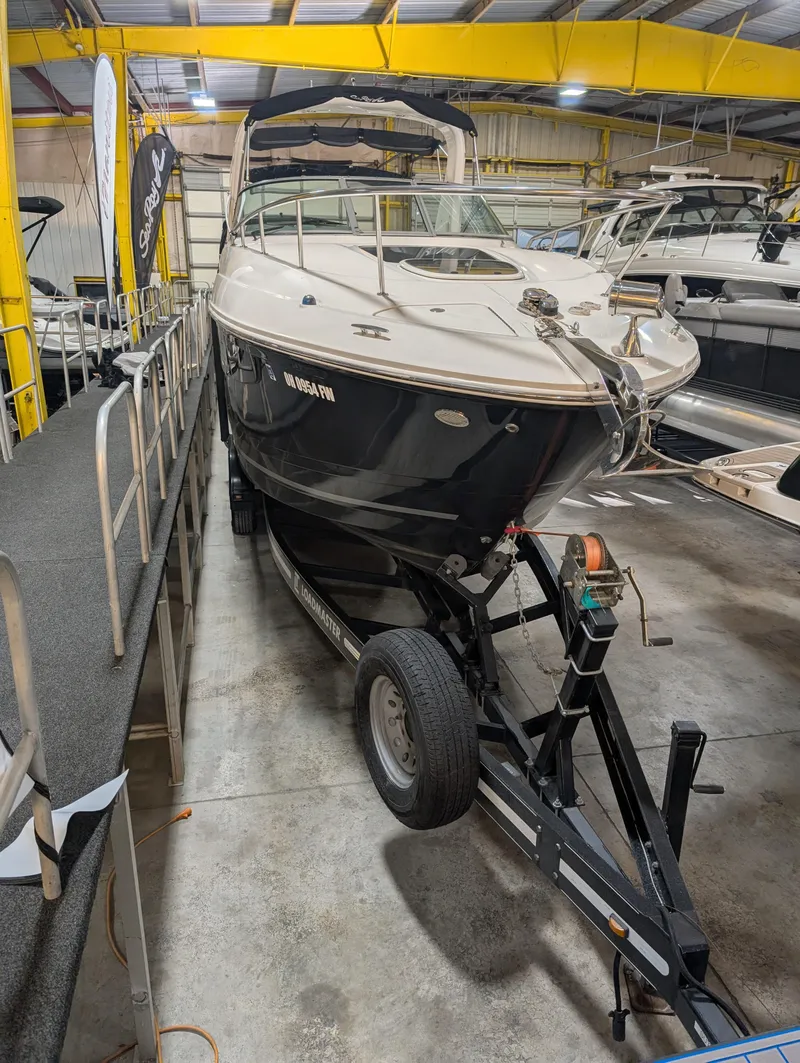 Slide: The Image of 2015 Sea Ray 280 Sundancer boat on trailer in indoor storage facility. - 34