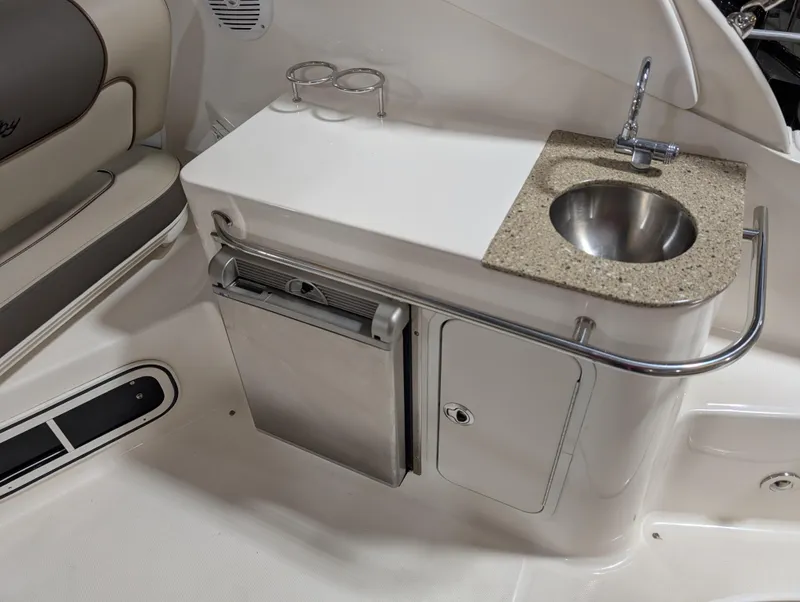 Slide: The Image of 2015 Sea Ray 280 Sundancer boat interior with sink and storage area. - 4
