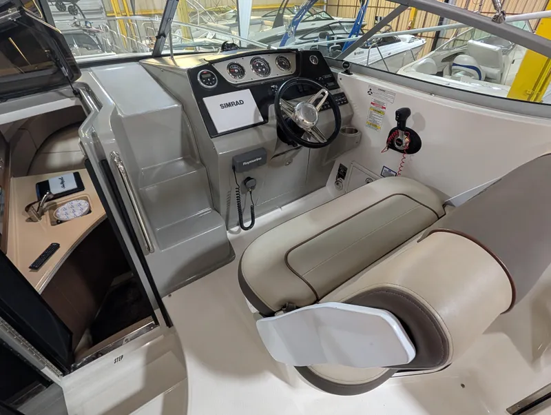 Slide: The Image of 2015 Sea Ray 280 Sundancer helm with steering wheel and navigation system. - 6