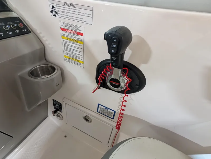 Slide: The Image of Sea Ray 280 Sundancer 2015 boat throttle control with safety lanyard and warning labels. - 8