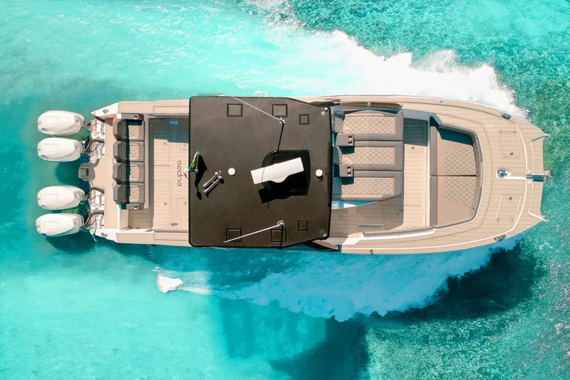 Slide: The Image of Aerial view of 2025 Sedna 370 Side Console boat on turquoise water. - 9