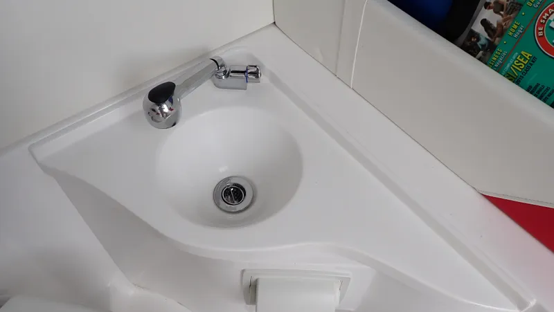 Slide: The Image of Compact white sink with chrome faucet in 2024 Statement 350 Open boat. - 10