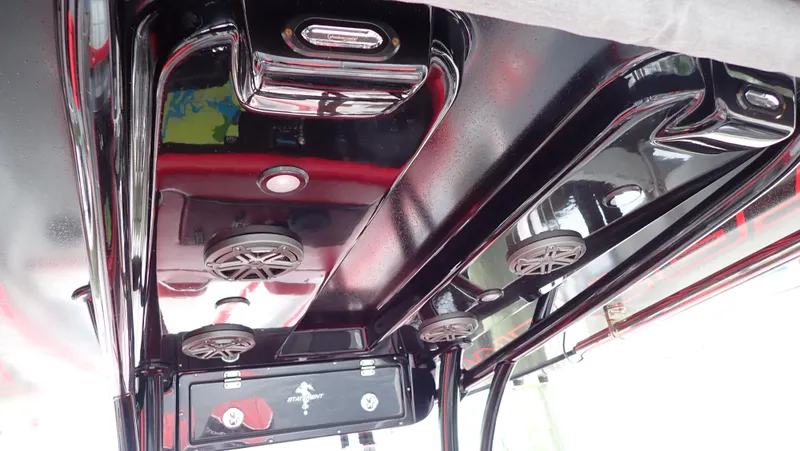 Slide: The Image of 2024 Statement 350 Open boat interior with sleek black finish and integrated speakers. - 16