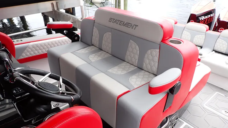Slide: The Image of 2024 Statement 350 Open boat interior with red and gray seating, featuring modern design. - 17