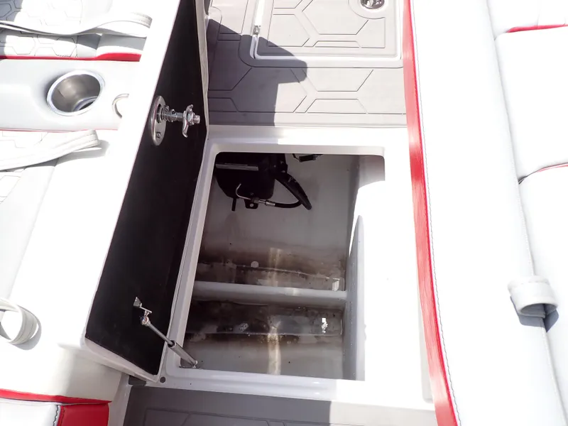 Slide: The Image of 2024 Statement 350 Open boat storage compartment with open hatch and cup holders. - 38