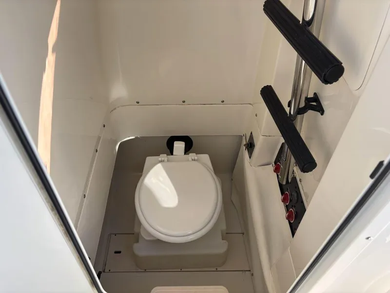 Slide: The Image of 2012 Hydra-Sports 2500 CC boat interior with compact marine toilet. - 10