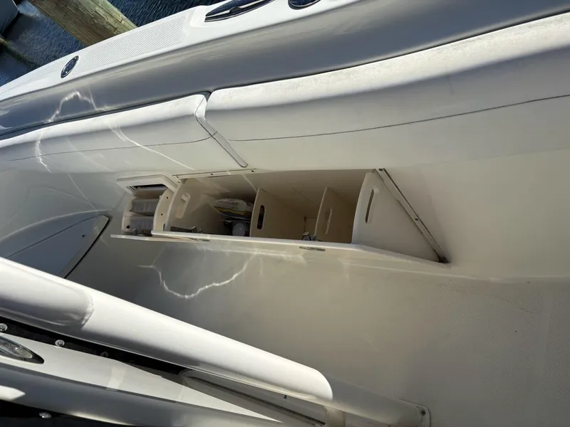 Slide: The Image of 2012 Hydra-Sports 2500 CC boat storage compartments, open and empty, viewed from above. - 11