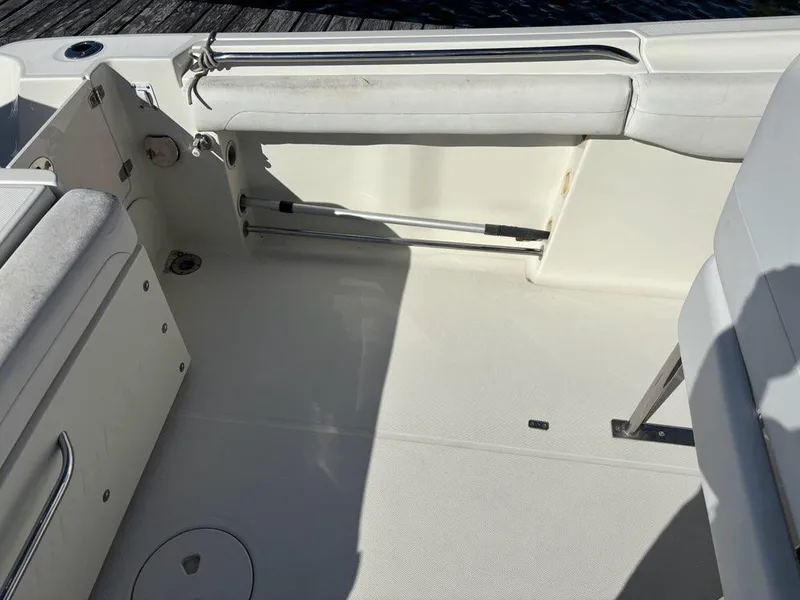 Slide: The Image of 2012 Hydra-Sports 2500 CC boat interior with white seating and clean deck. - 13