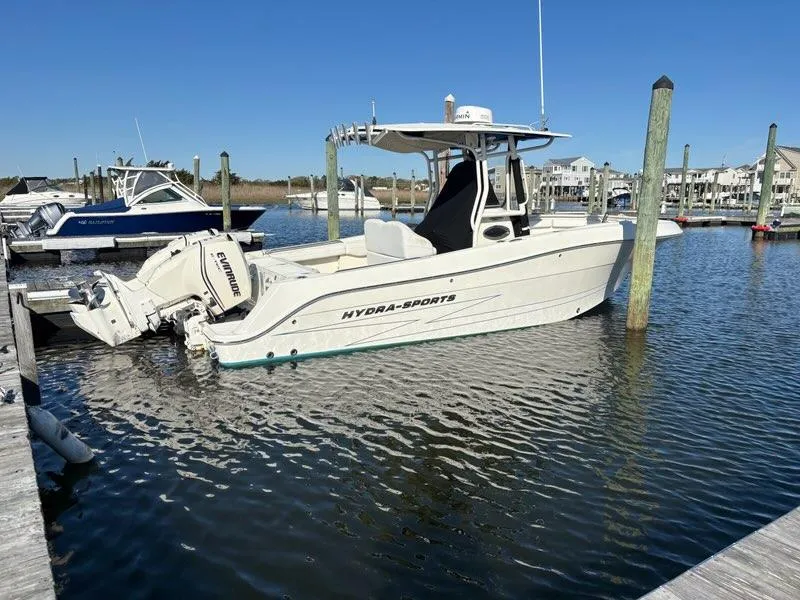 Slide: The Image of 2012 Hydra-Sports 2500 CC boat docked in a marina under clear blue skies. - 2