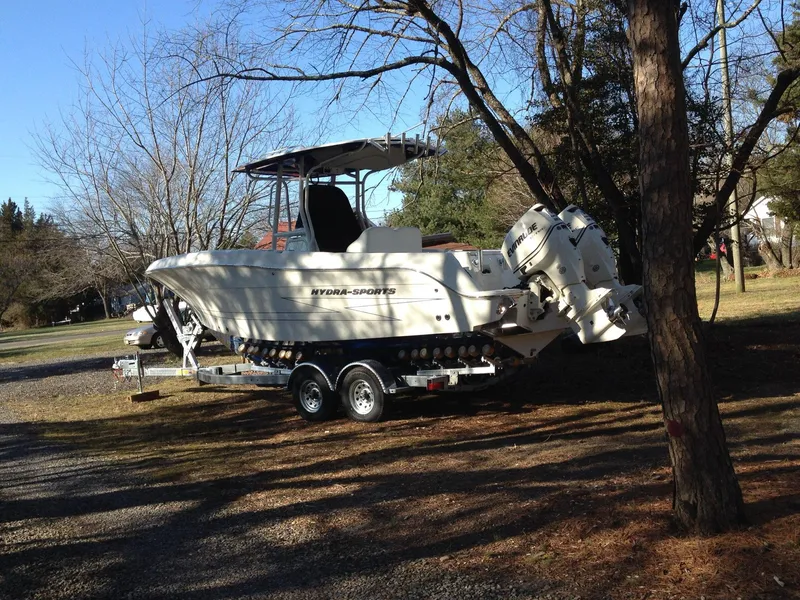 Slide: The Image of 2012 Hydra-Sports 2500 CC boat on trailer, parked outdoors near trees. - 3