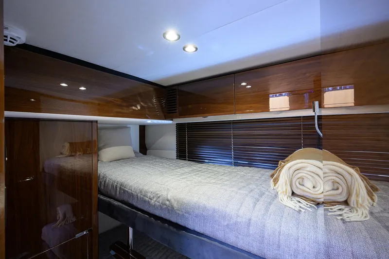 Slide: The Image of Luxurious cabin interior of 2018 Princess 65S yacht with cozy bedding and elegant wood finishes. - 31