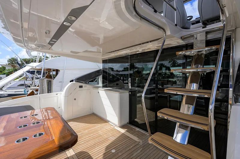 Slide: The Image of Luxurious 2018 Princess 65S yacht deck with wooden table and sleek staircase. - 37