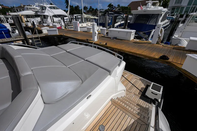 Slide: The Image of Luxury Princess 65S yacht docked at marina, showcasing sleek design and spacious deck. - 41