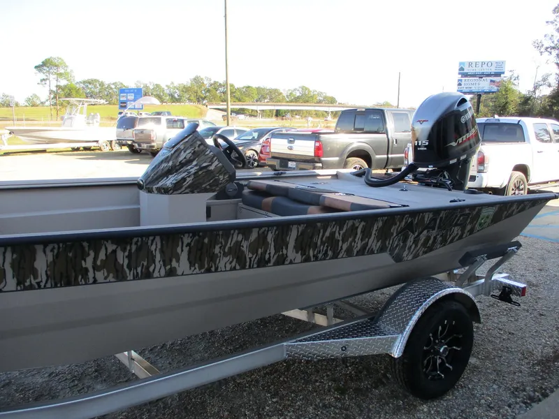 Slide: The Image of Avid 18 Rogue SC 2025 boat with camouflage design on a trailer in a parking lot. - 4