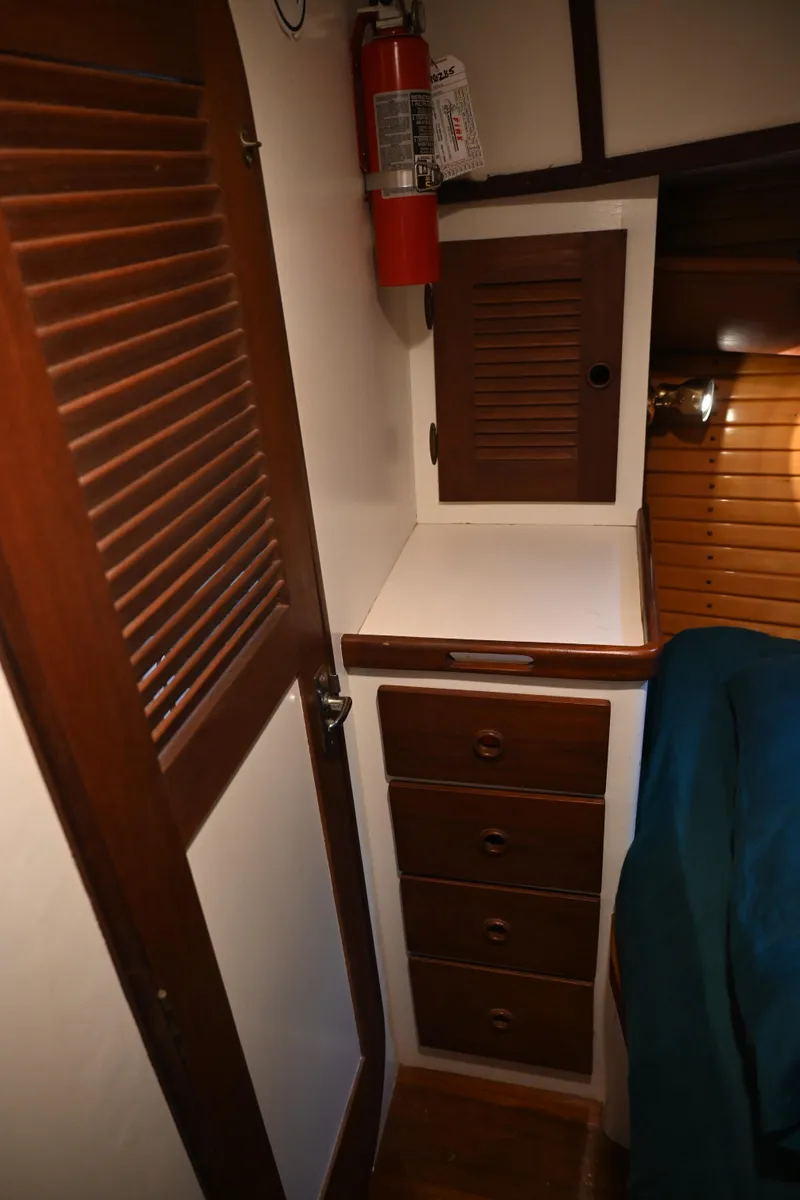 Slide: The Image of 1984 Southern Cross 39 interior with wooden cabinets and fire extinguisher. - 37