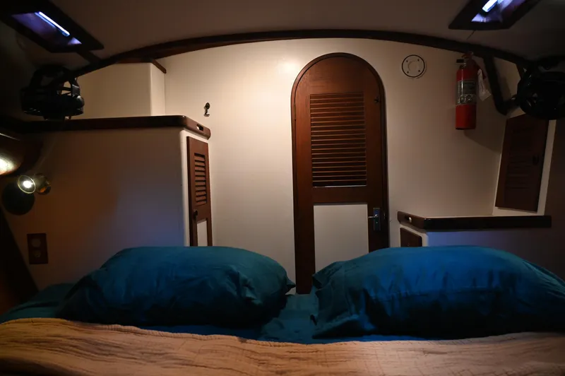 Slide: The Image of Cozy cabin interior of 1984 Southern Cross 39 sailboat with blue bedding. - 39
