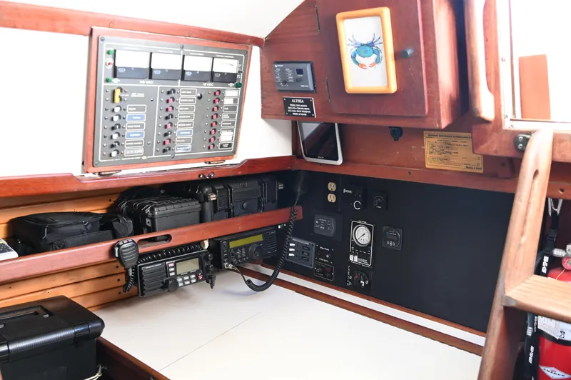Slide: The Image of Navigation station of 1984 Southern Cross 39 sailboat with control panels and communication equipment. - 42
