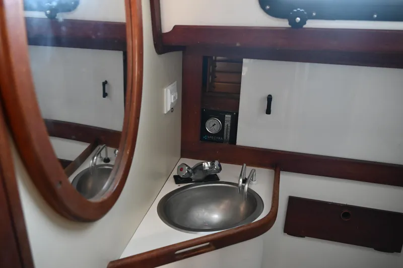 Slide: The Image of 1984 Southern Cross 39 yacht bathroom with sink and mirror. - 47