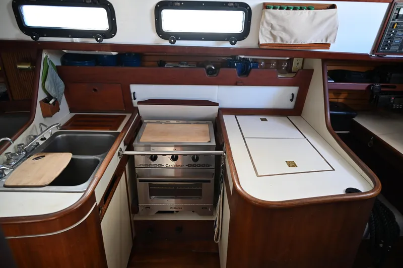 Slide: The Image of 1984 Southern Cross 39 yacht kitchen with stove, sink, and storage. - 49