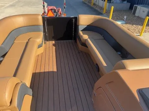 Slide: The Image of 2025 Bentley Pontoons 253 Elite Swingback Dual Captain interior with tan and gray seating. - 3