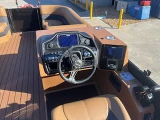 Slide: The Image of 2025 Bentley Pontoons 253 Elite Swingback Dual Captain dashboard with modern controls and steering wheel. - 8