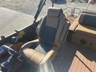 Slide: The Image of 2025 Bentley Pontoons 253 Elite Swingback Dual Captain seat, luxurious design, tan and gray upholstery. - 9