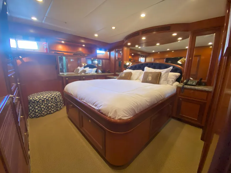 Slide: The Image of Luxurious bedroom interior of a 2005 Offshore Yachts 72', featuring elegant wood finishes. - 11