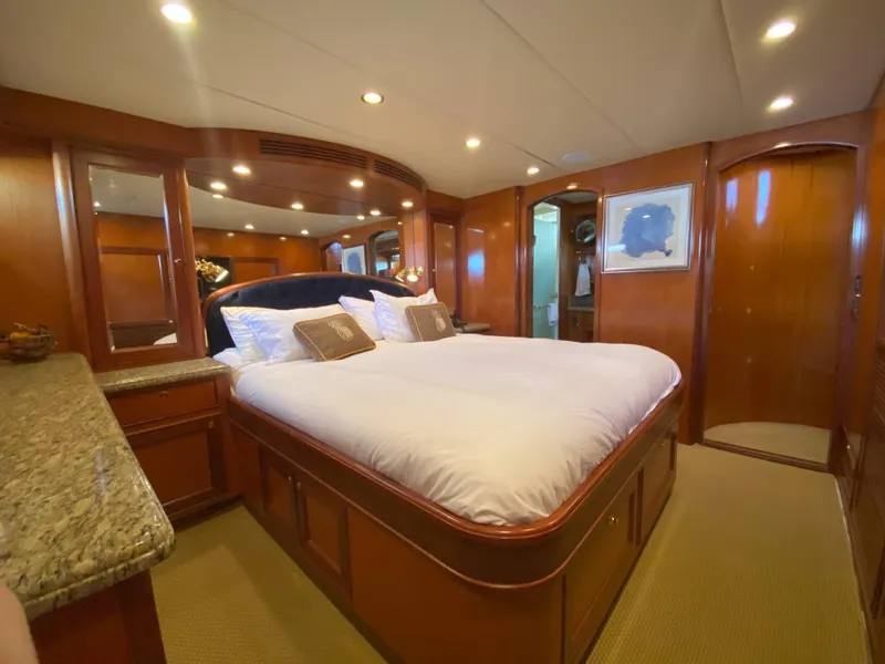 Slide: The Image of Luxurious bedroom interior of a 2005 Offshore Yachts 72' with elegant wood finishes. - 12