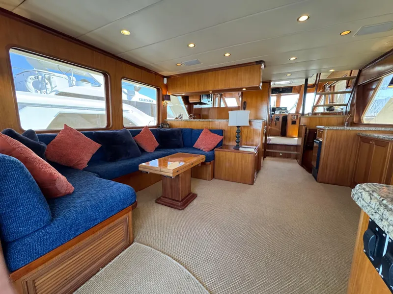 Slide: The Image of Luxurious interior of a 2005 Offshore Yachts 72', featuring elegant wood finishes and plush seating. - 2