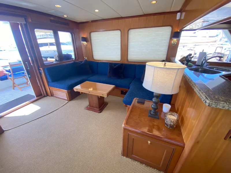 Slide: The Image of Luxurious interior of a 2005 Offshore Yachts 72', featuring elegant seating and wooden accents. - 3